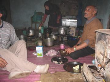 Old man cooking dinner in the village