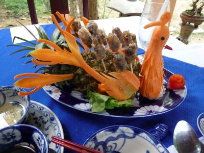 Spring rolls served on a pineapple peacock in Hue